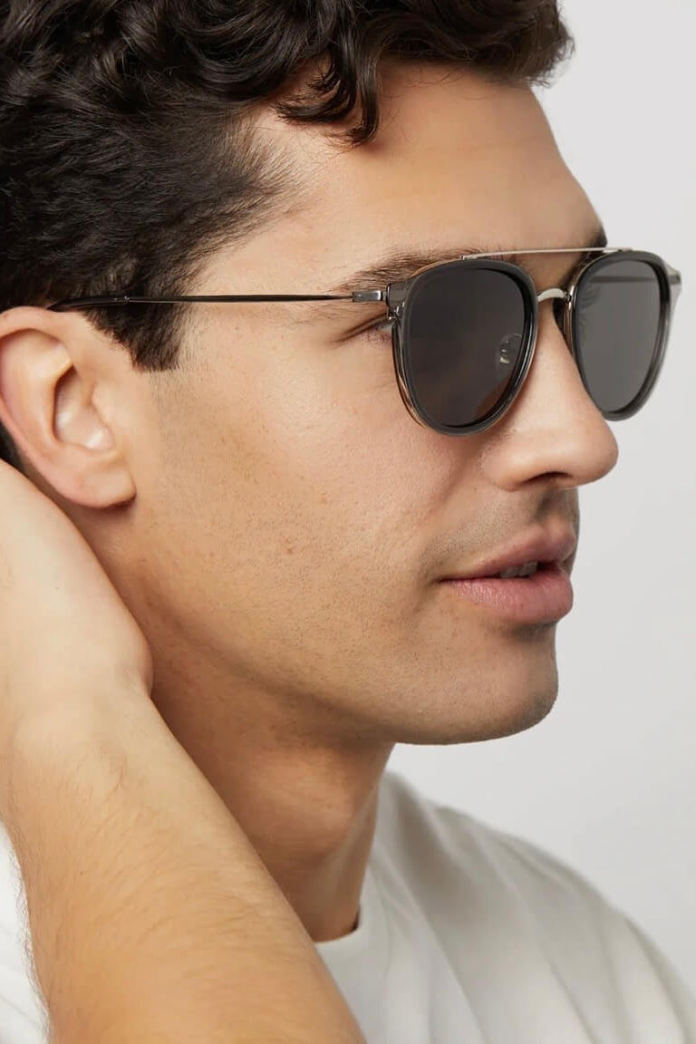 Man wearing the Diff Eyewear Camden Polarized Sunglasses in Black Smoke Crystal