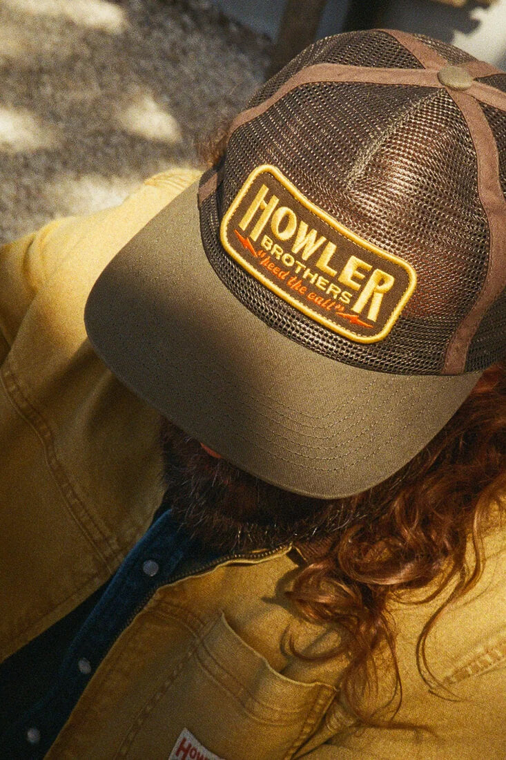 Howler Brothers Inside Out Feedstore Snapback men's unstructured five-panel mesh hat with pliable bill and adjustable snapback closure.