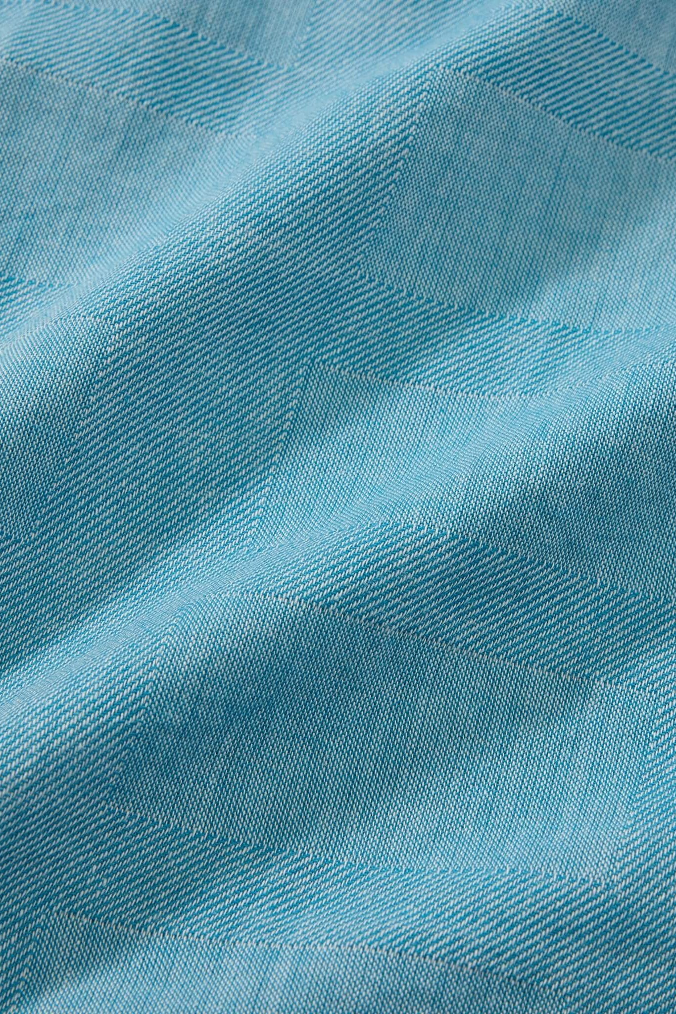 Close-up of blue fabric with a textured pattern
