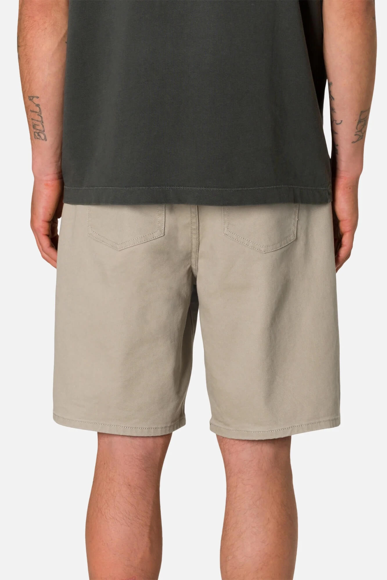 Person wearing Katin George 64 Bull Denim Short in Vintage Khaki and a dark shirt on a plain background