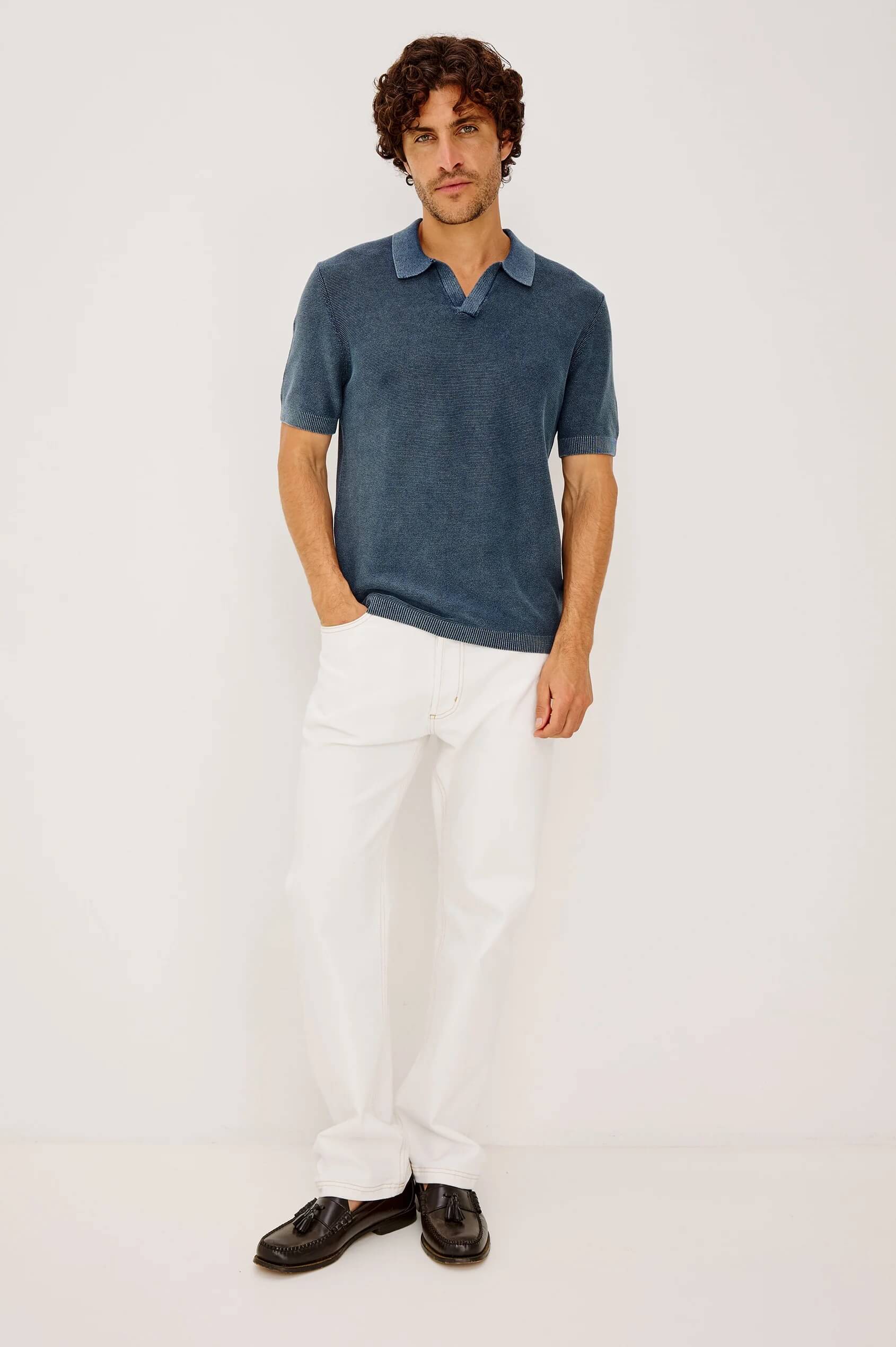 Model wearing the Baker Polo in Sunwashed Navy by Rails