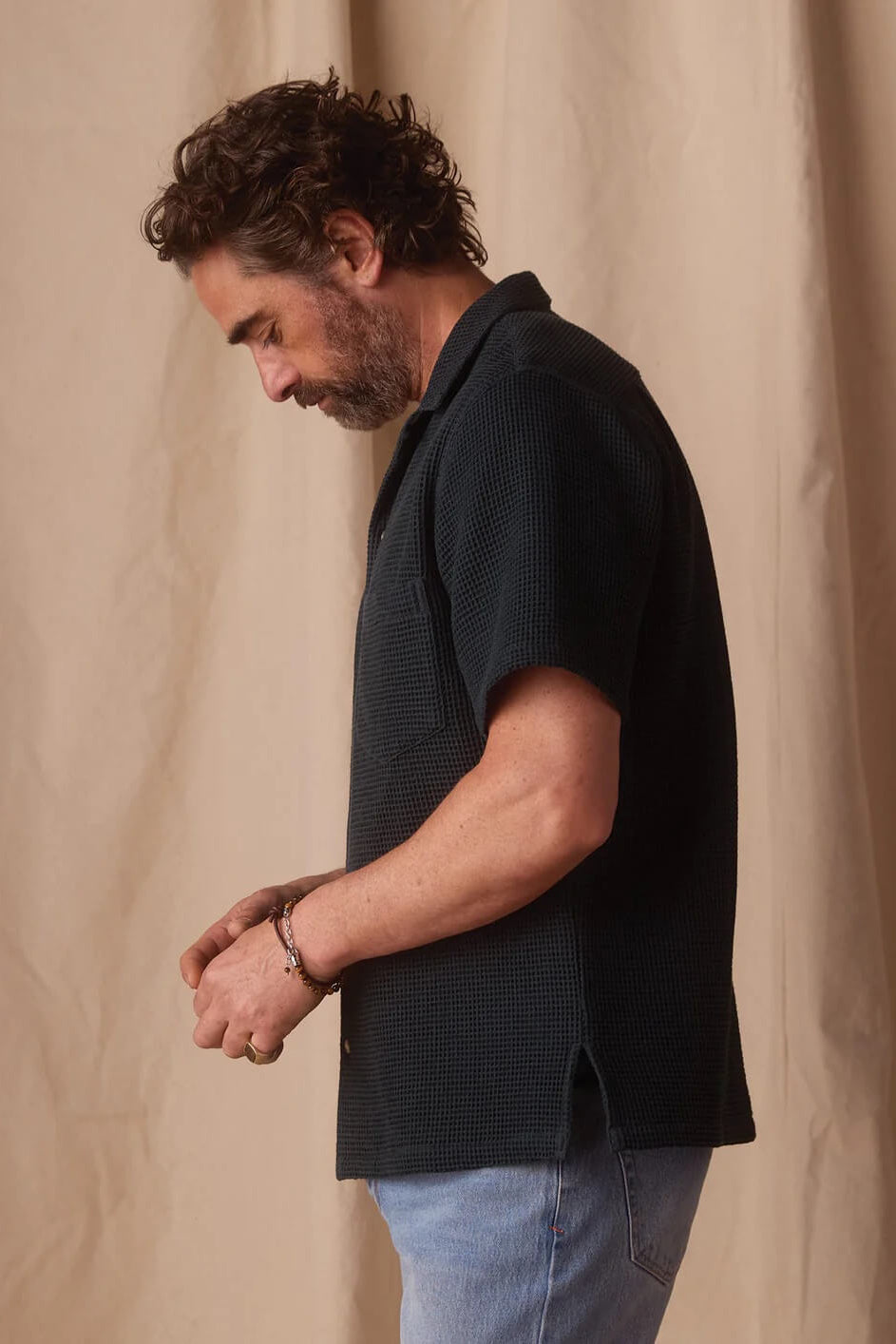 Model wearing The Normal Brand Freshwater Resort Shirtin Tunica in Dark Oasis
