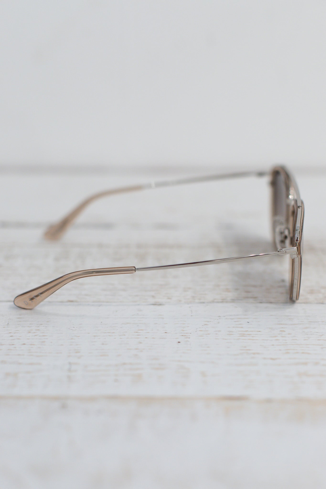 Sunglasses on a light wooden surface