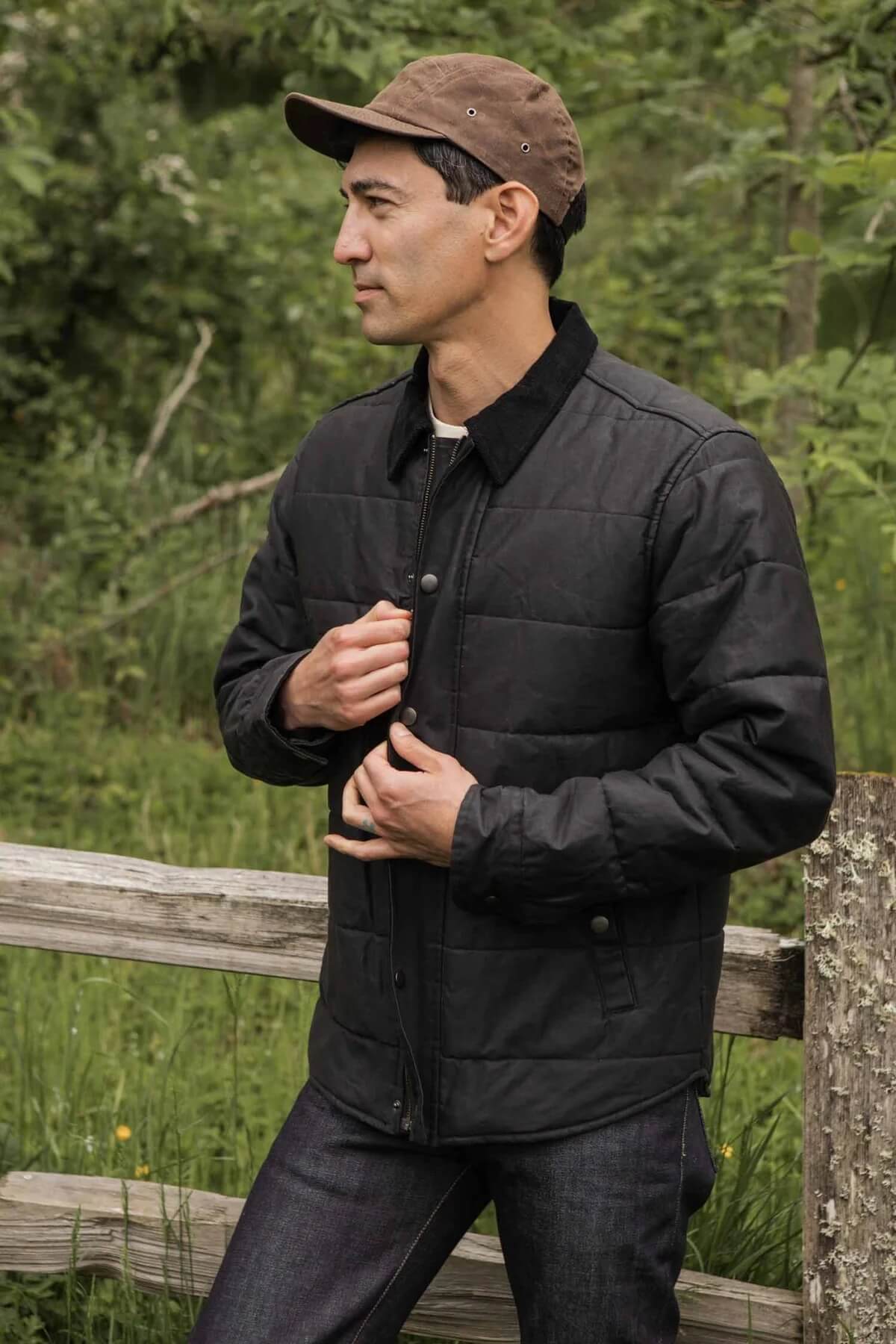 Man wearing The Holman Quilted Jacket in Black Waxed Canvas
