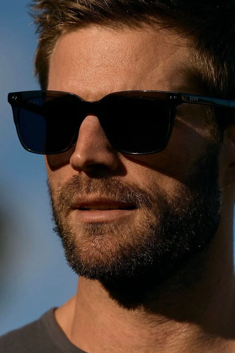 Man Wearing the Diff Eyewear Billie XL Polarized Sunglasses in Smoke Crystal + Grey