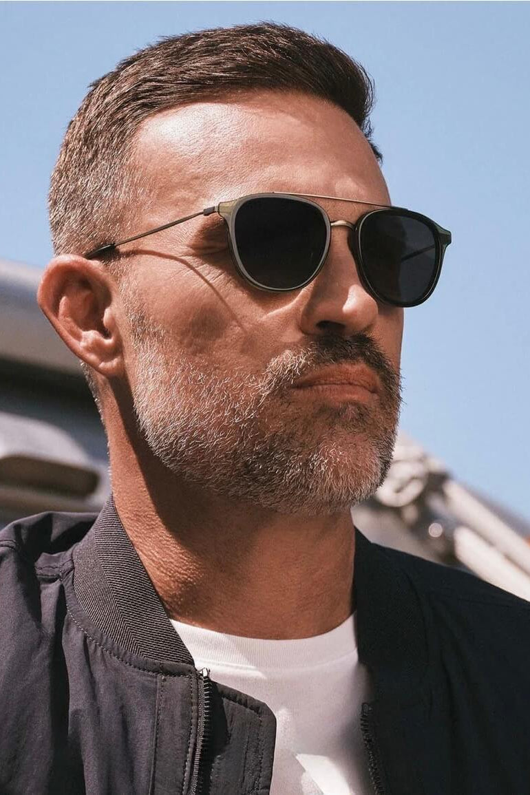 Man wearing the Diff Eyewear Camden Polarized Sunglasses in Dark Olive Crystal