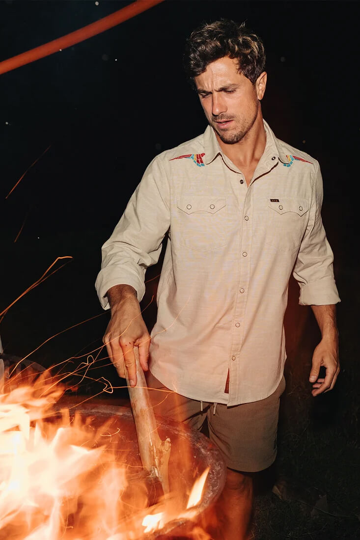 Howler Brothers Crosscut Deluxe Snapshirt men's regular-fit stretch chambray shirt with custom embroidery, western yokes, and pearl snaps.