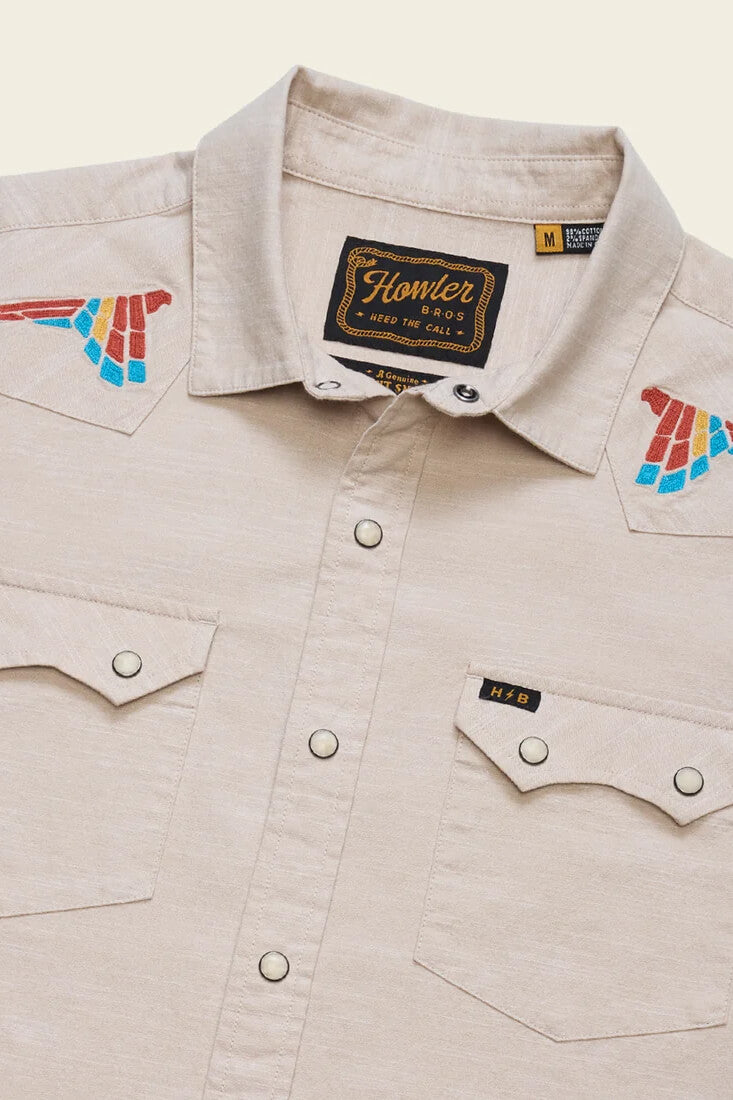 Howler Brothers Crosscut Deluxe Snapshirt men's regular-fit stretch chambray shirt with custom embroidery, western yokes, and pearl snaps.