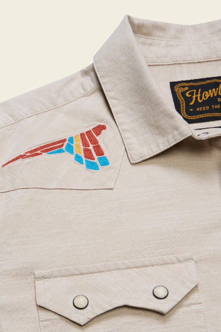 Howler Brothers Crosscut Deluxe Snapshirt men's regular-fit stretch chambray shirt with custom embroidery, western yokes, and pearl snaps.