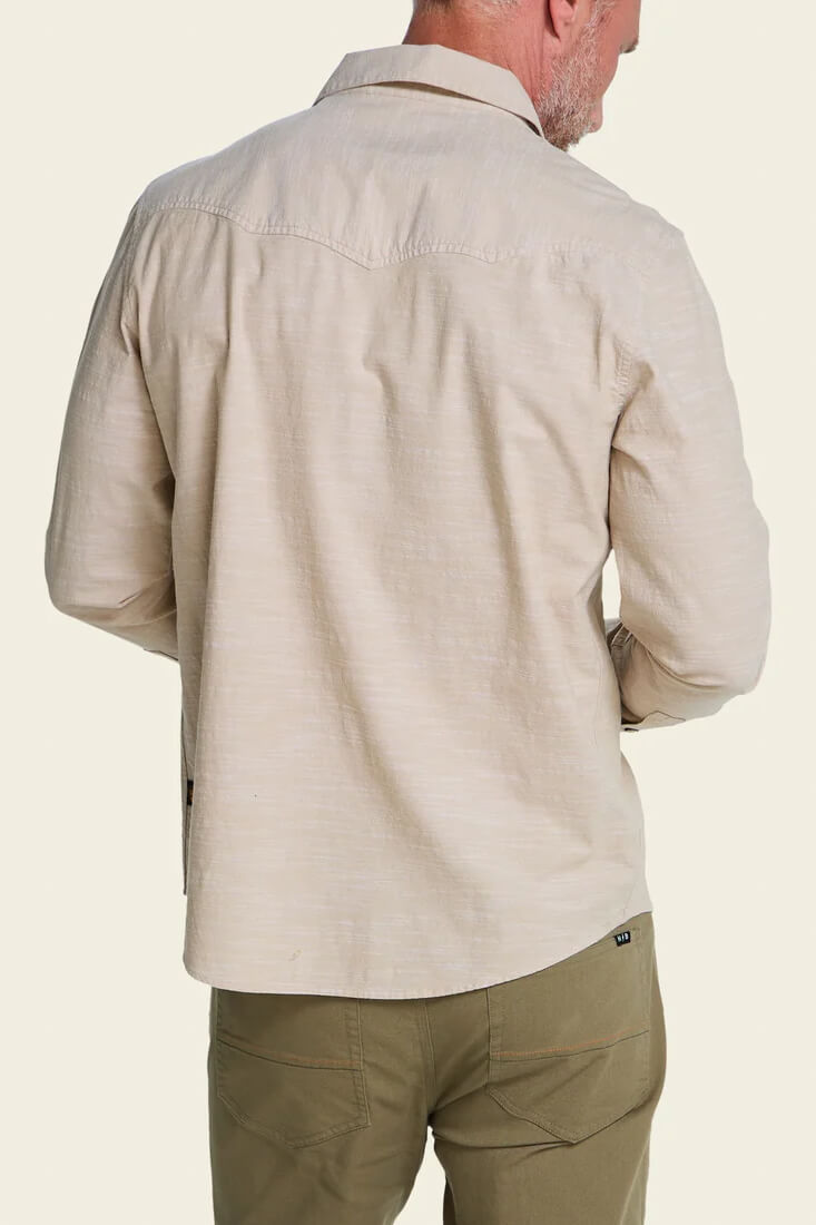 Howler Brothers Crosscut Deluxe Snapshirt men's regular-fit stretch chambray shirt with custom embroidery, western yokes, and pearl snaps.