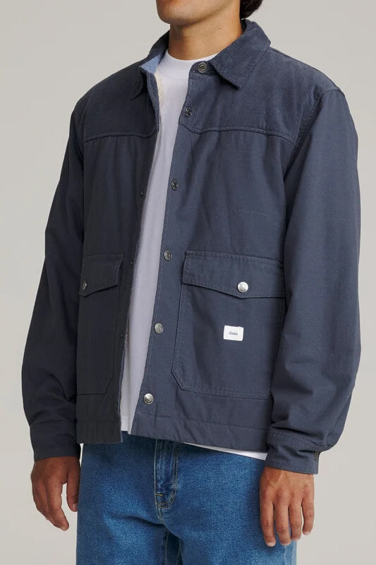 Katin Yukon Jacket featuring a quilted cotton canvas shell, corduroy collar, sherpa lining, snap-front closure, and utility pockets.
