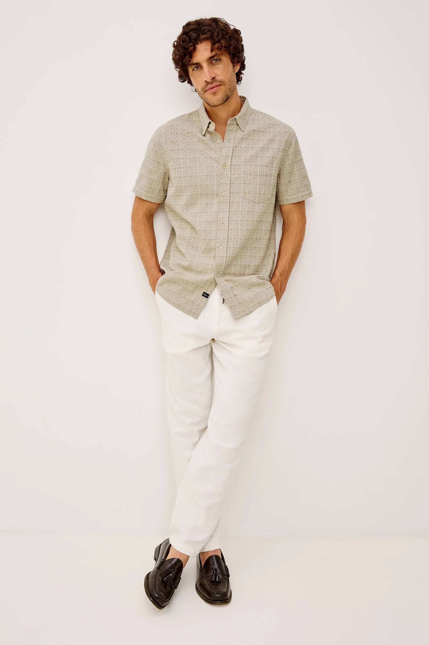 A man wearing Rails Gavin shirt in Taupe Cream Twist, standing against a plain white studio background.