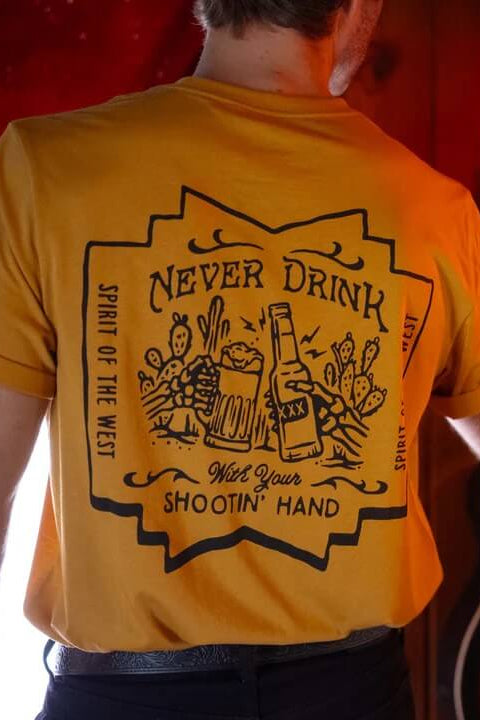 Man wearing the Sendero Shootin' Hand Salud Tee in Goldenrod 