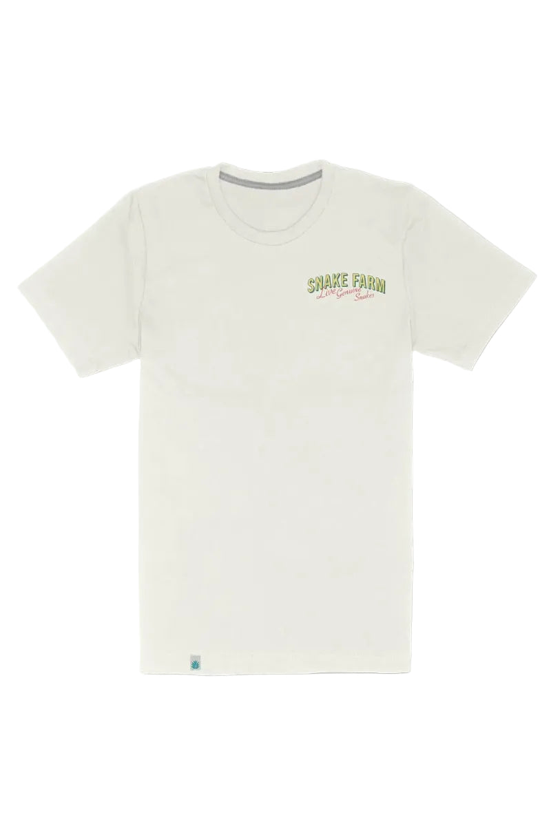 An off-white short-sleeve crewneck t-shirt with a small 'Shake Farm' logo printed on the left chest in green and red, displayed against a solid white background.